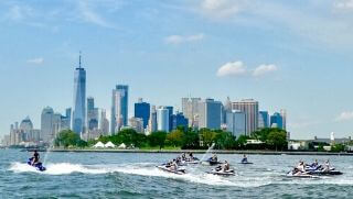multiple jet skis with bluetooth speakers on the water