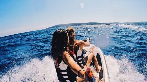 jet ski on the water with passenger and mounts with speakers
