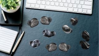 various sets of multipoint bluetooth earbuds on a desk