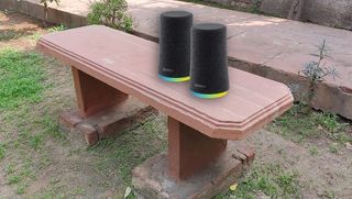 compact bluetooth speakers on a bench
