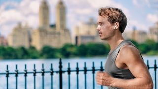 guy running wearing ipx8 earbuds
